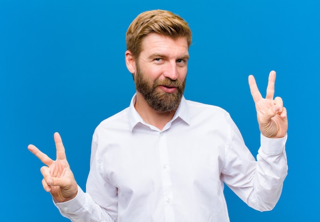 Smiling and looking happy, friendly and satisfied, gesturing victory or peace with both hands