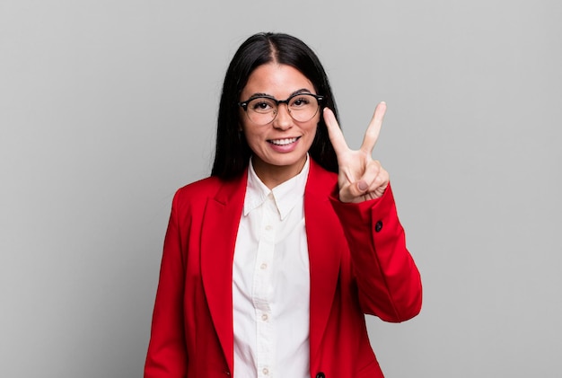 Smiling and looking happy gesturing victory or peace