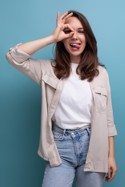 Smiling lovely brunette year old female person in shirt and jeans is happy