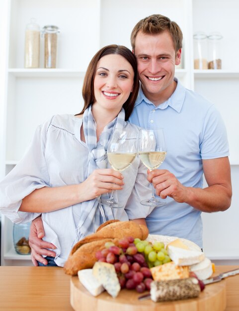 Smiling lovers drinking white wine