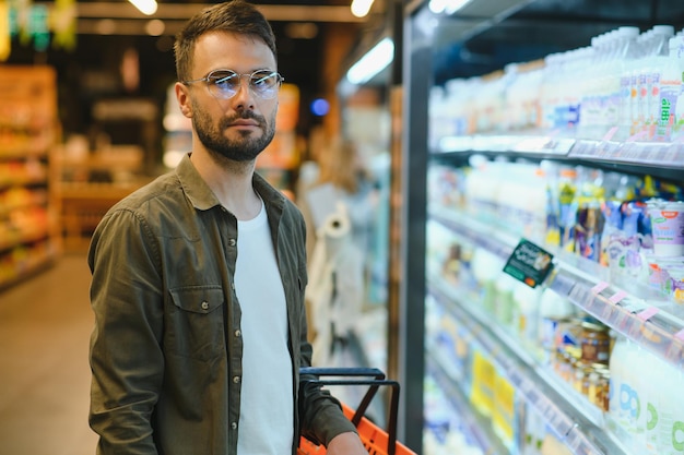 Smiling male customer doing grocery shopping