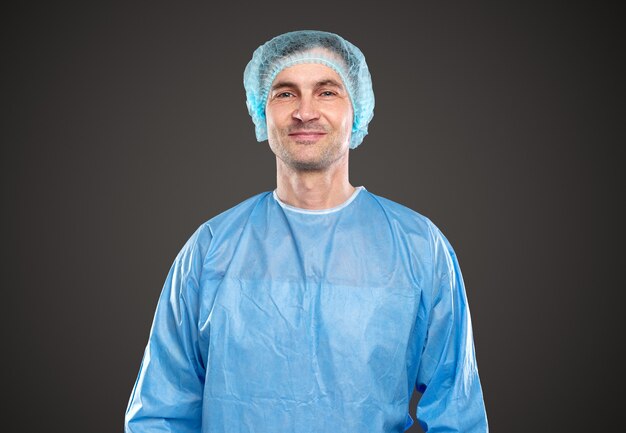 Photo smiling male doctor in protective medical suit