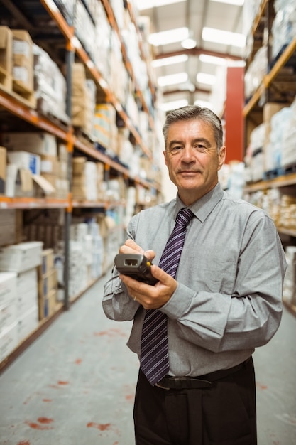 Smiling male manager using handheld