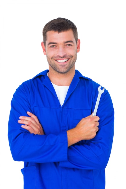 Smiling male mechanic holding spanner