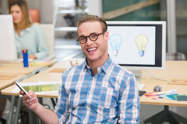 Smiling male photo editor in office