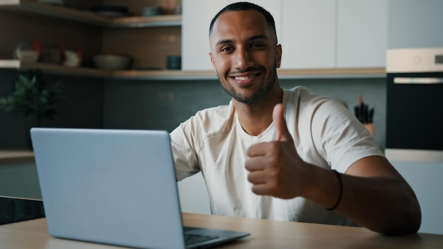 Smiling male winner happy successful african millennial man guy american user freelancer at home