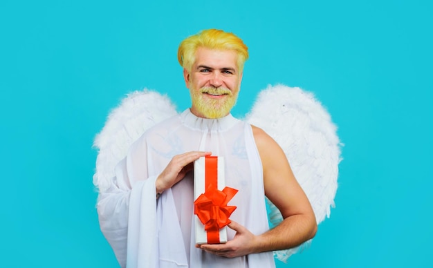 Smiling man in angel wings valentine present cupid with gift box valentines day shopping