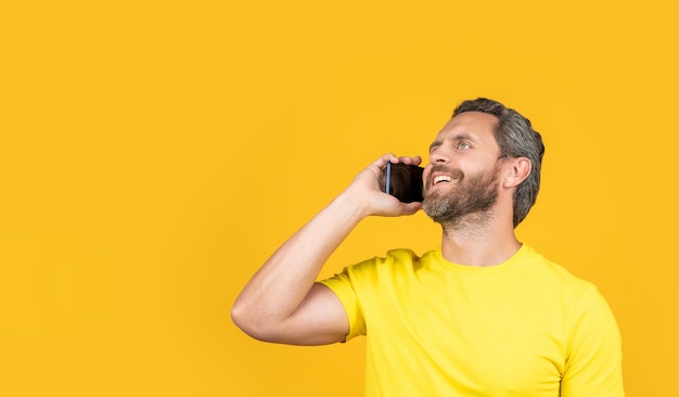 smiling man call on phone on background copy space man call on phone in studio