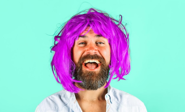Smiling man in color wig isolated on green background portrait of bearded man with colorfull hair