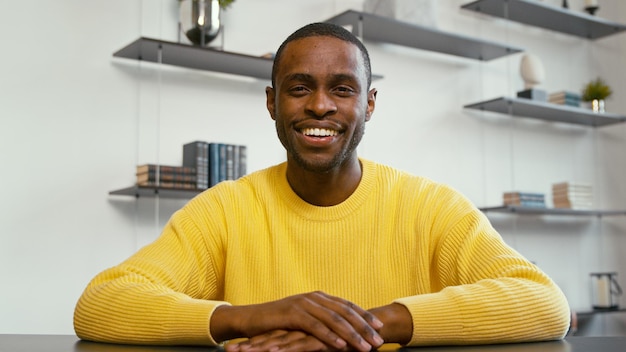 Smiling man communicating by videoconference