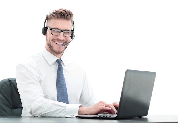 Smiling man in headphones working on a laptop