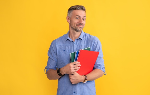 Smiling man hold school notebook or planner, teacher