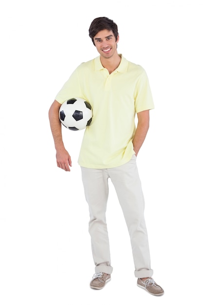 Smiling man holding soccer ball