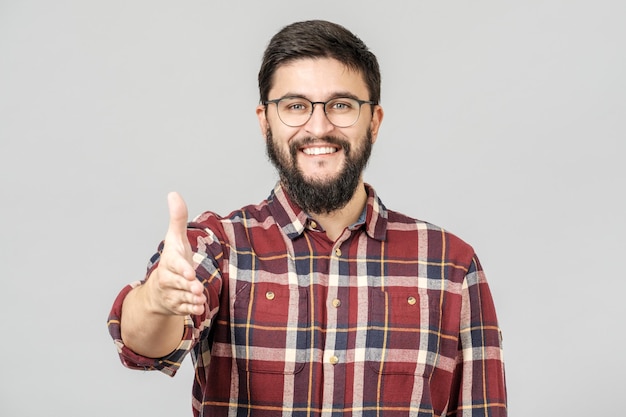 Smiling man holds out his hand for a handshake