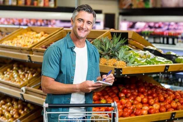 Smiling man looking at his list