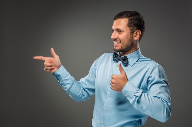 Smiling man pointing to something with an index finger