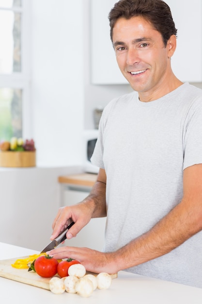 Smiling man preparing vegetables