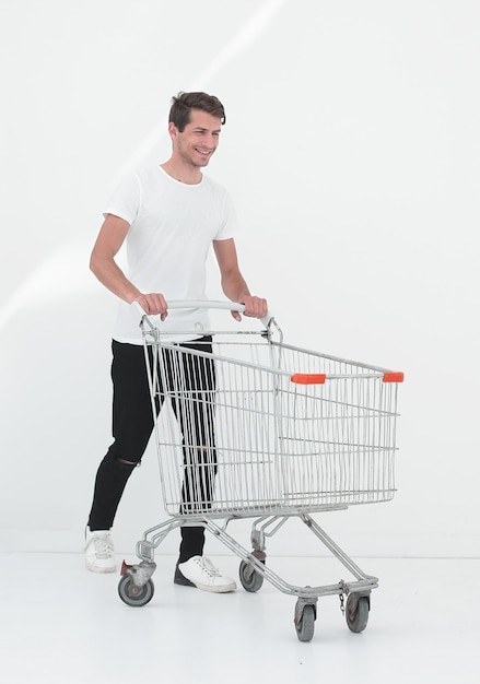 Smiling man pushing shopping cart