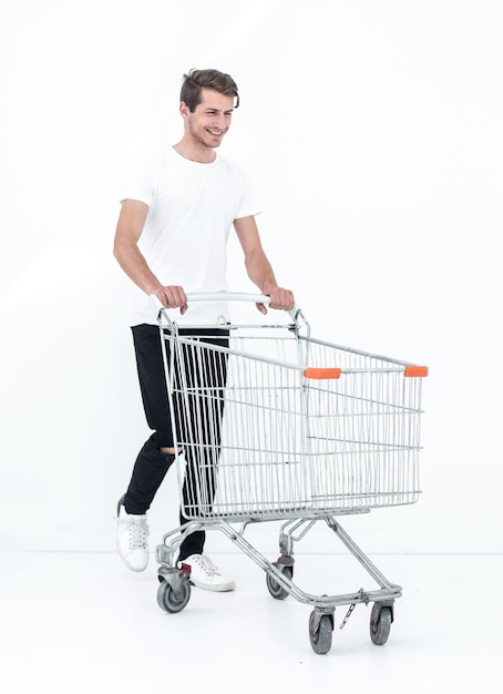 Smiling man pushing shopping cart