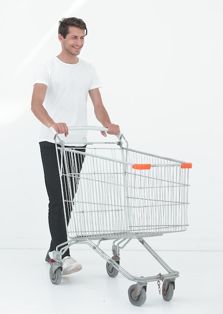 Smiling man pushing shopping cart