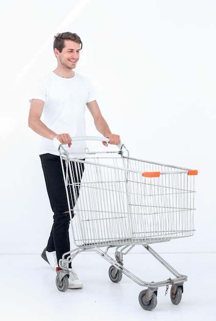 Smiling man pushing shopping cart