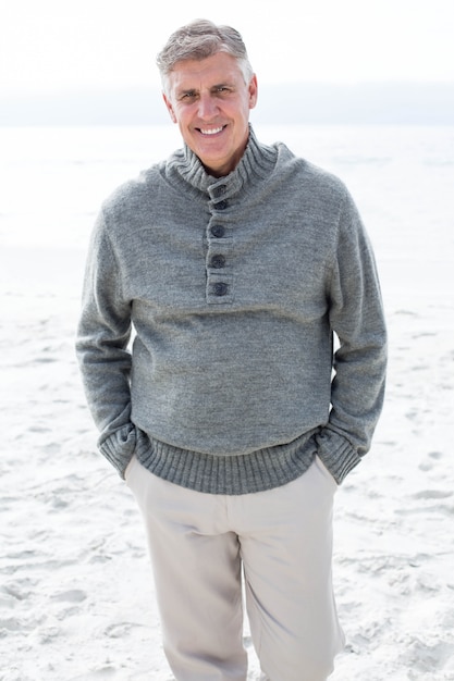 Smiling man standing in the sand