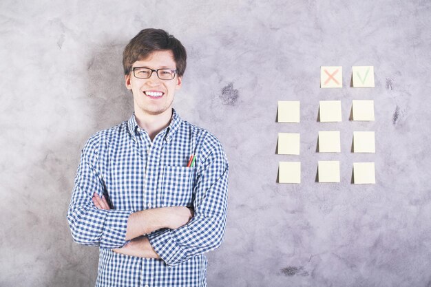 Smiling man next to stickers