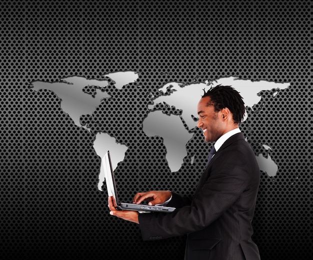 Smiling man in suit holding a laptop