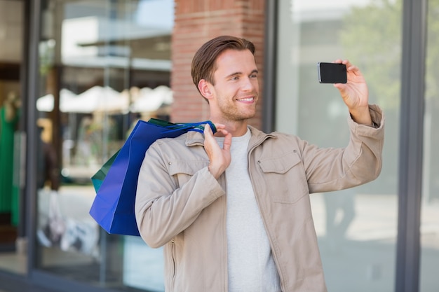 A smiling man taking a selfie