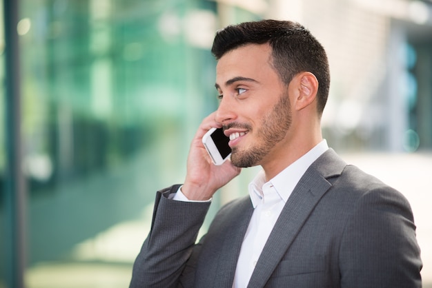 Smiling man talking on the cell phone