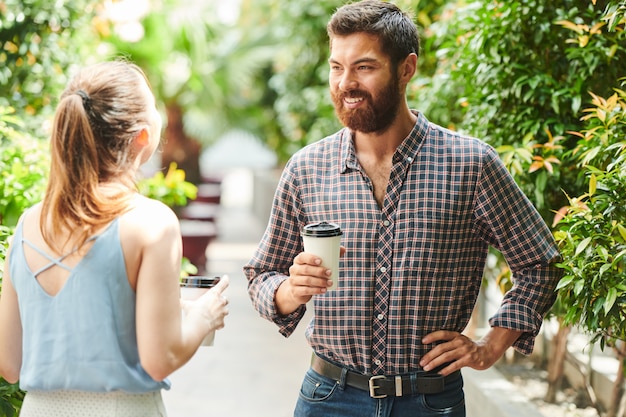 Smiling man talking to friend outdoors