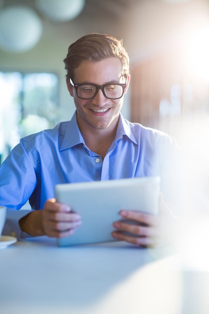 Smiling man using digital tablet