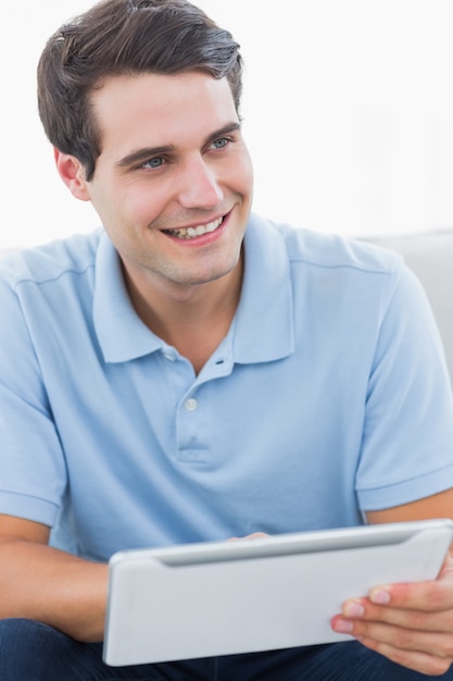 Smiling man using his tablet 