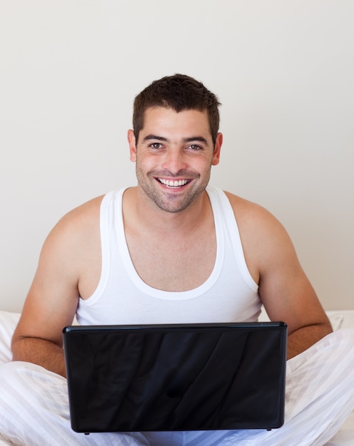 Smiling man using laptop