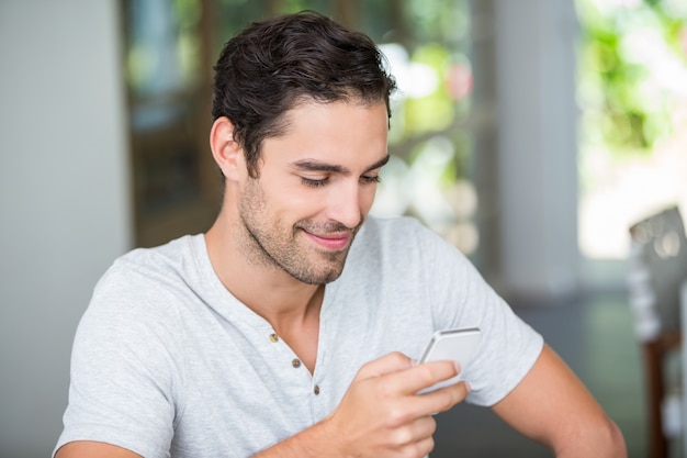 Smiling man using smartphone 