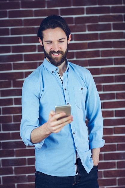 Smiling man using smartphone