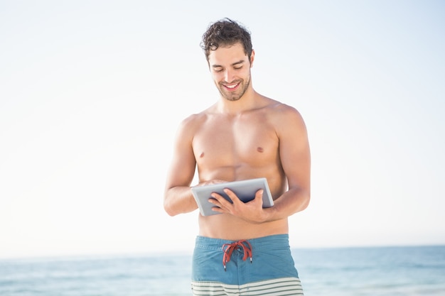 Smiling man using tablet