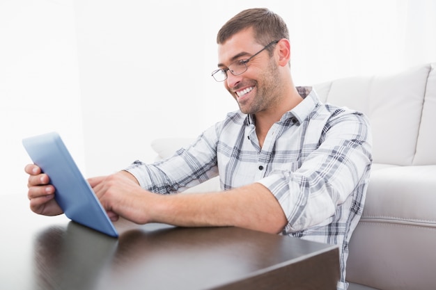 A smiling man using a tablet 