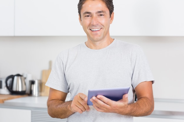 Smiling man using tablet 