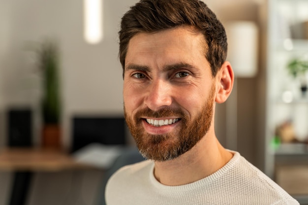 Smiling man wearing spectacles looking at camera. Successful entrepreneur feeling satisfied. Stock photo