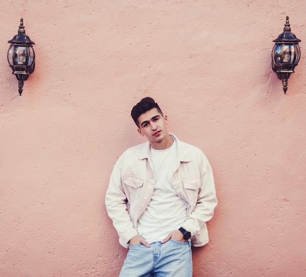 Smiling man in white denim jacket