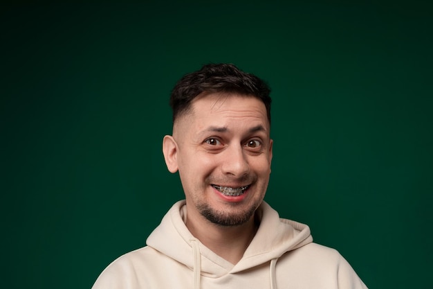 Smiling man in white hoodie