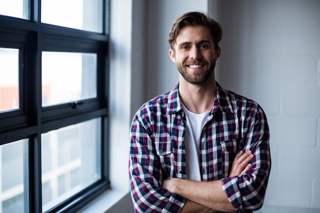  smiling man with arms crossed in office