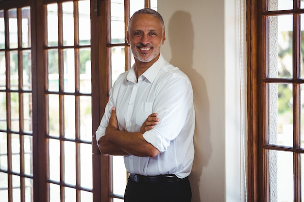 Smiling man with arms crossed