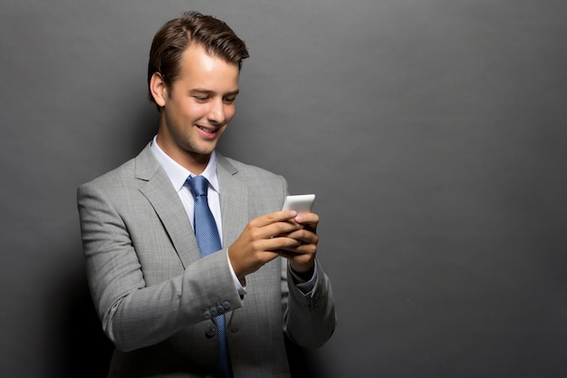 A smiling man with a handphone isolated