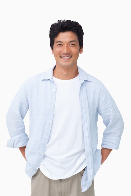 Smiling man with hands in his pockets