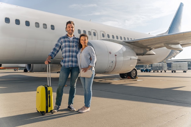 Smiling man and woman waiting for the flight together