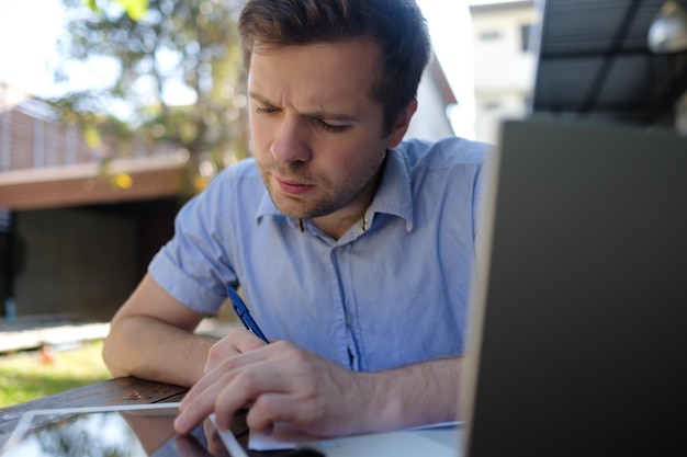 Smiling man working at home on laptop computer