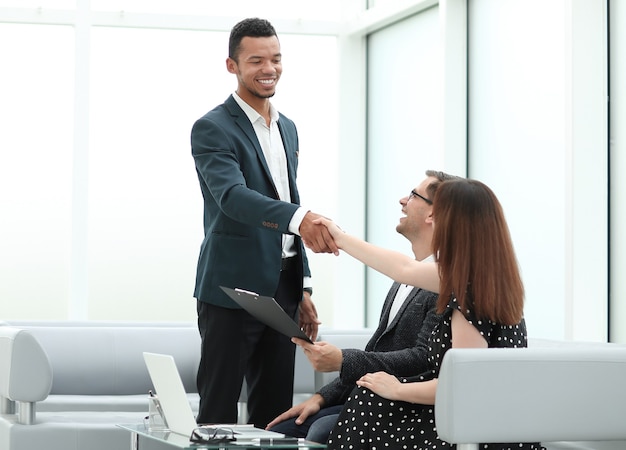 Smiling Manager greets customers in the lobby of the office. photo with copy space