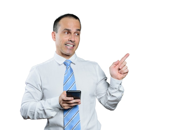 Smiling mature Brazilian man in formal wear and pointing his finger to his left.